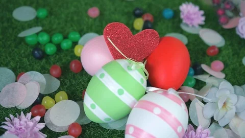 Close-up panoramic of hidden red glitter heart between Easter eggs Stock Footage 101290754