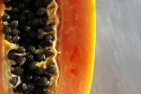 Close up of papaya fruit on the kitchen table. Stock Photos