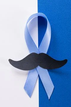 Close-up of paper mustache and blue prostate cancer awareness ribbon on white Stock Photos