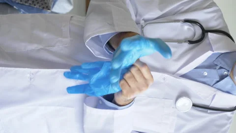 Close-up of a paramedic's hands putting on protective rubber gloves Stockbeeldmateriaal 150689215