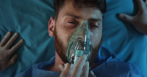 Close up of paramedics take off ill bearded guy face oxygen inhalation mask. Man Stock-Footage 139822779