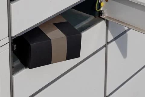 Close-up of a parcel placed in a parcel machine, the courier company's auto.. Stock Photos