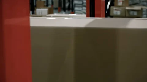 Close-up of parcels in a warehouse with cardboard box moving along the packaging Stock Footage 128294867