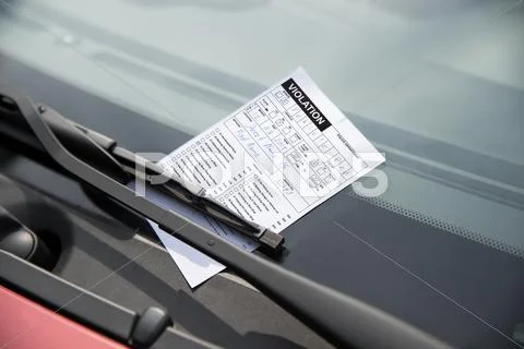 Close-up of parking ticket on car's windshield Stock Photos
