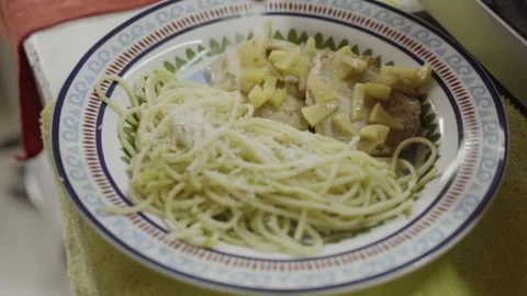 Close Up of Parmesan Cheese Being Sprinkled Over Spaghetti With Creamy Chicken Stock Footage 345898475