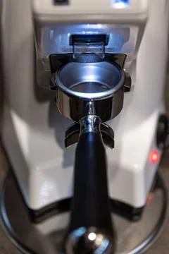 Close-up part of a coffee machine, a holder for coffee. Stock Photos