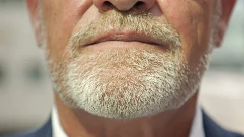Close-up. Part of the face of a smiling mature man with a gray beard. Stock Footage 159352078