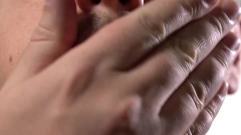Close-up part of the face. a young man runs his hand over his unshaven face Stock Footage 145469297