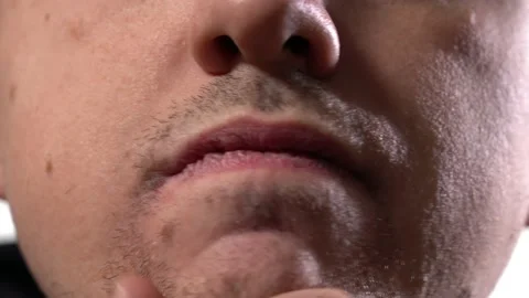 Close-up part of the face. a young man runs his hand over his unshaven face Stock Footage 146256862