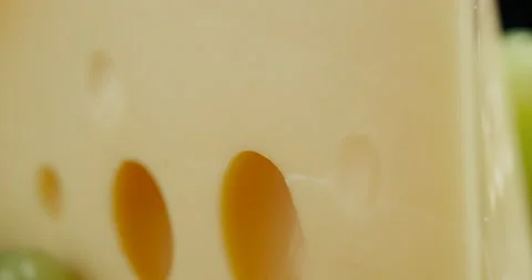 Close up part of Medium hard cheese head edam gouda parmesan on wooden board Video stock 146397124