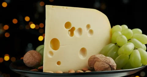 Close up part of Medium hard cheese head edam gouda parmesan on wooden board Stock Footage 146840910