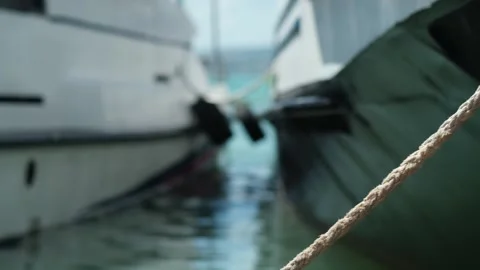 Close up of part of moored passenger ship. bow of ship with rope near shore with Stock Footage 280229663