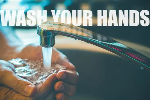 Close-up partial view of caucasian man washing hands in the sink of bathroom Stock Photos