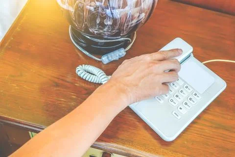 Close-up partial view of hand man calling by phone in hotel room Stock Photos