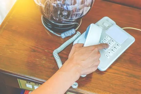 Close-up partial view of hand man calling by phone in hotel room Foto stock