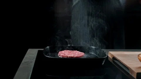 Close-up partial view of man near frying pan with grilled meat Stock Footage 87270200