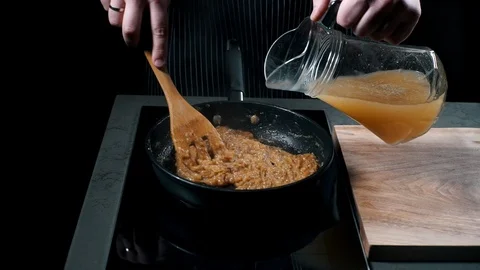 Close-up partial view of man near frying pan who is preparing the sauce Stock Footage 87270353