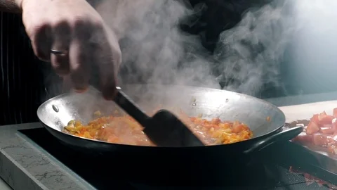 Close-up partial view of man preparing paella in a frying pan. Stock-Footage 87268811