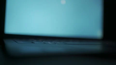 Close-Up of a Partially Opened Laptop with Glowing Screen | HLG Video stock 312357611