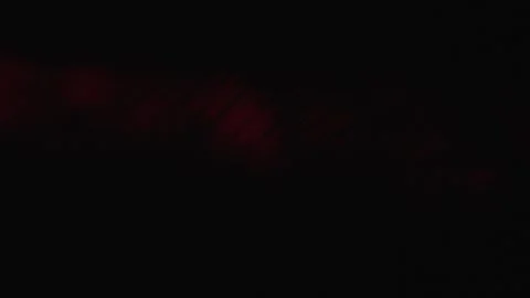 Close-up of Particles in Red Light Beam Stock Footage 267055700