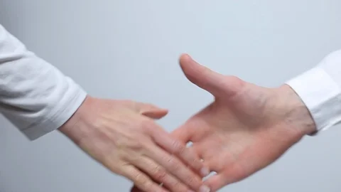 Close-up of a partners shaking hands on a white background. Stock Footage 119233697