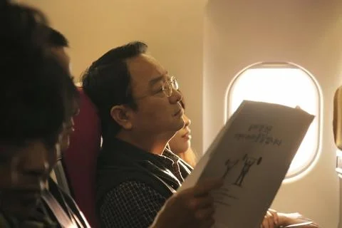 Close up of passengers in the cabin of plane. Stock Photos