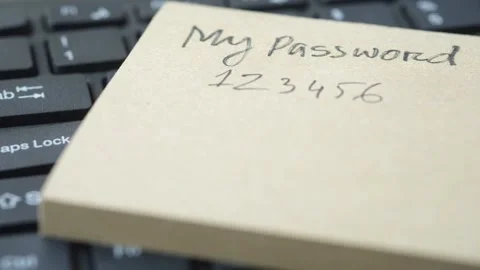 Close up of password written on sticky note on keyboard, security concept. Stock Footage 332858829