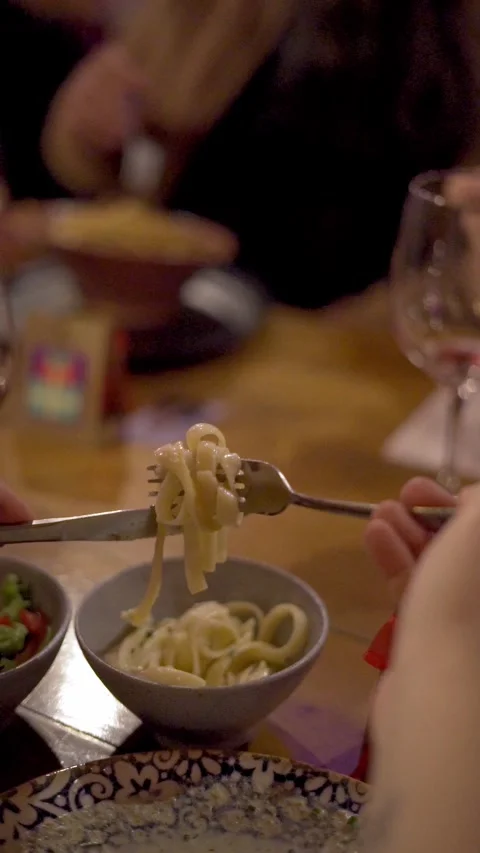 Close-up of pasta being lifted with fork in restaurant, slow motion food moment Video stock 330377794