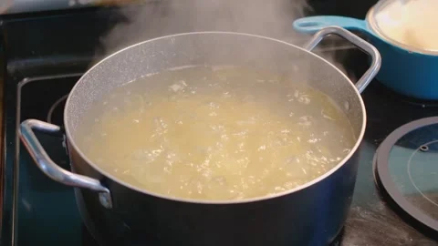 Close Up of Pasta Boiling in Large Pot with Steam Stock Footage 332498225
