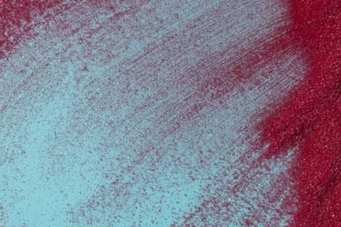 Close up of pastel coloured sand splashed red  background. Stock Photos