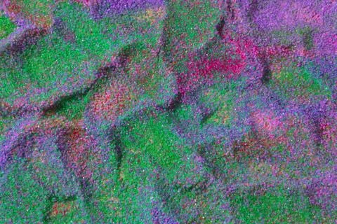 Close up of pastel coloured sand splashed red  background. Stock Photos