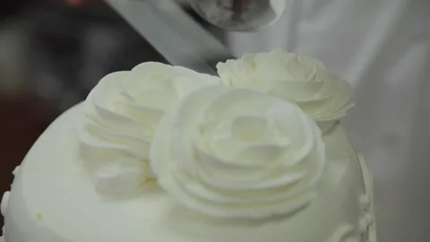 Close-Up of Pastry Chef Adding Decorations to Elegant Wedding Cake Stock Footage 231414145