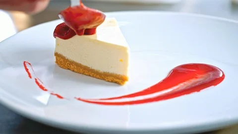 Close-up of the pastry chef decorating a cake with red jam before serving Stock-Footage 85591175