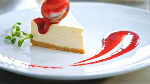 Close-up of the pastry chef decorating a cake with red jam before serving Видео 85591288