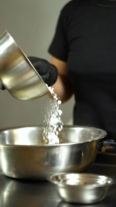 Close-up of a pastry chef mixing ingredients for a delicious bakery recipe Stock Footage 285543390
