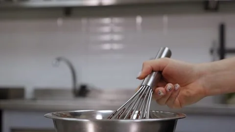 Close-up of a pastry chef mixing liquid chocolate with a whisk in the kitchen. Stock Footage 136834426