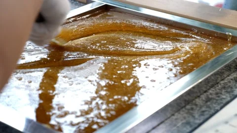 Close-up of a pastry chef mixing liquid sugar caramel with a spatula. Stock Footage 330522426