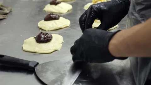 Close-up of a pastry chef preparing sweet rolls with cottage cheese and jam. Stock Footage 339788296