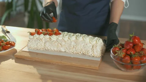 Close-up. The Pastry Chef Puts Fresh Strawberries on a Meringue Cake With Cream. Stock Footage 163165364
