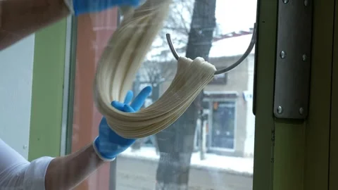 Close-up of a pastry chef stretching liquid caramel on a hook in a pastry shop. Stock Footage 330869722