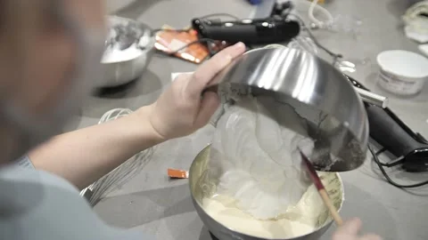 Close-up of a pastry chef whips an egg white with a blender, cooking bizet. 動画素材 171462931
