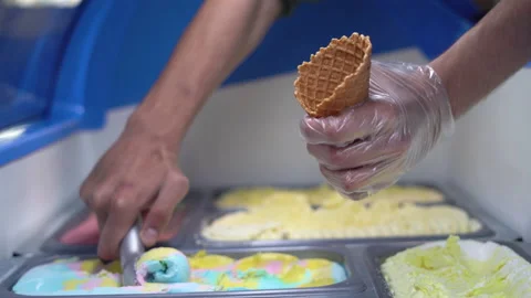 Close-up of a pastry chef's hands take delicious and cold Italian ice cream in Stock Footage 156506397