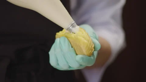 Close-up, Pastry in Gloves Begins Eclair Milk Cream Stock Footage 136885905