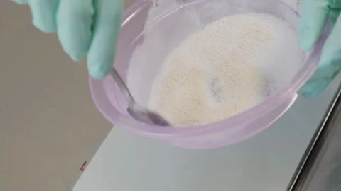 Close-up, Pastry Hands in Gloves Stir Ingredients for Cream in Plastic Bowl Stock Footage 136800874