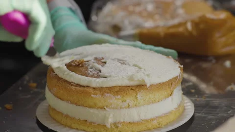 Close-up, Pastry Hands Impose Milk Cream on Biscuit Cake Stock Footage 140490647