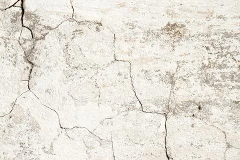 A close-up of a patch of old, cracked white plaster. Stock Photos
