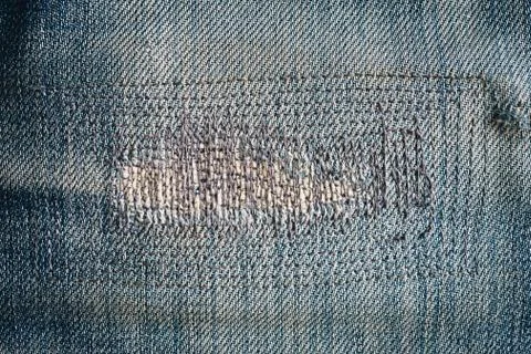 Close up patch old jeans denim texture and background. Stock Photos