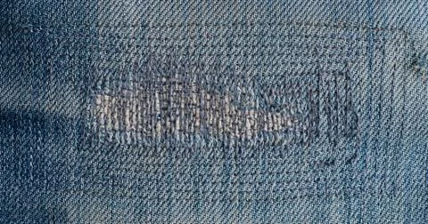 Close up patch old jeans denim texture and background. Stock Photos