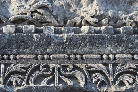 Close-up pattern on antique stone column.Elements of ancient Greek architectu Stock Photos