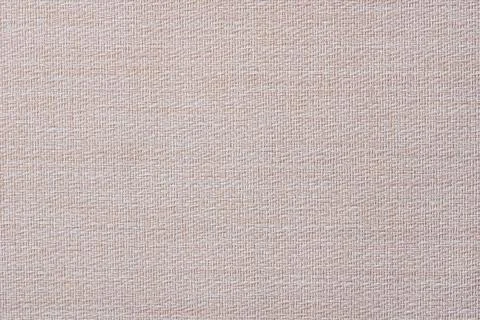 Close-up of a pattern of fabric imitating a natural canvas. Beige. Stock Photos